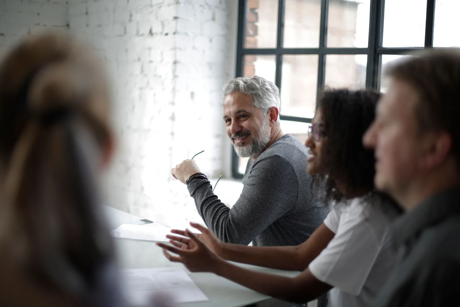 An engaged corporate team in a bright working session, the kind of team that brings Abigail in